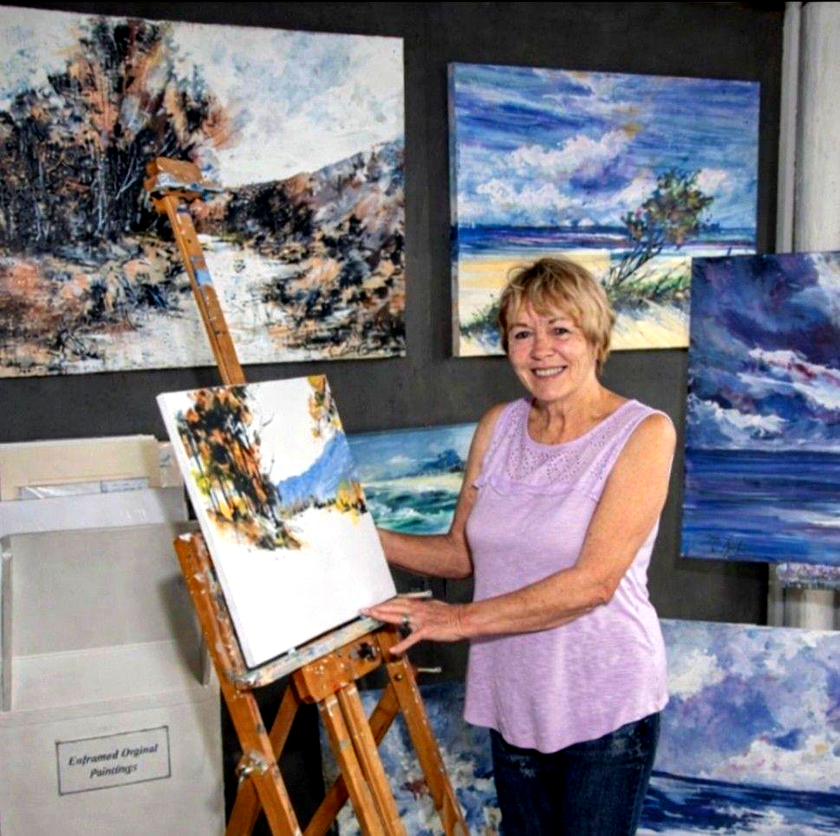 Diane White standing with her artwork