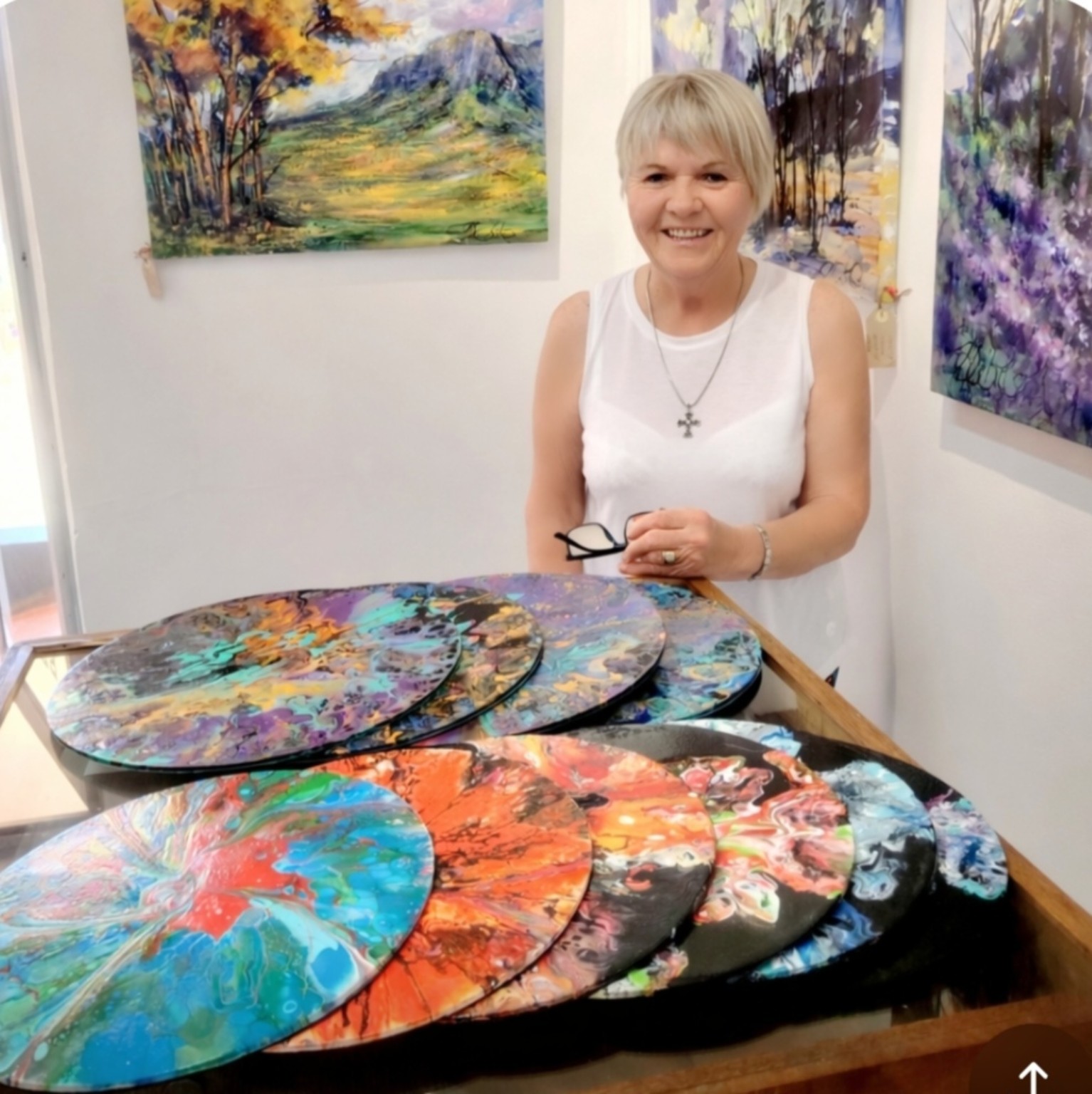 Diane White with selected artworks in the gallery